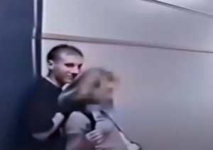 Eric Harris pretends to kidnap Brandi Tinklenberg in the Columbine High School hallway.