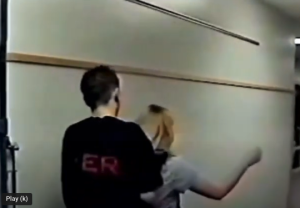 Eric Harris pretends to kidnap Brandi Tinklenberg in the Columbine High School hallway.
